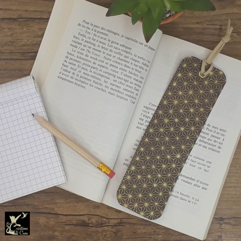 Ne perdez plus le fil de vos lectures ! Ce marque-page artisanal, recouvert d'un élégant papier japonais chocolat au motif étoilé deviendra votre allié.