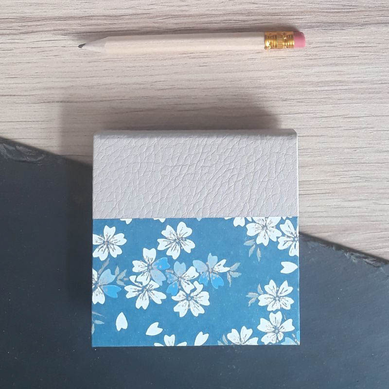 Porte bloc à post-it de la marque de papeterie lilloise : les créations du caou. Papier japonais bleu marine, fleurs de sakura blanches et bleu ciel.